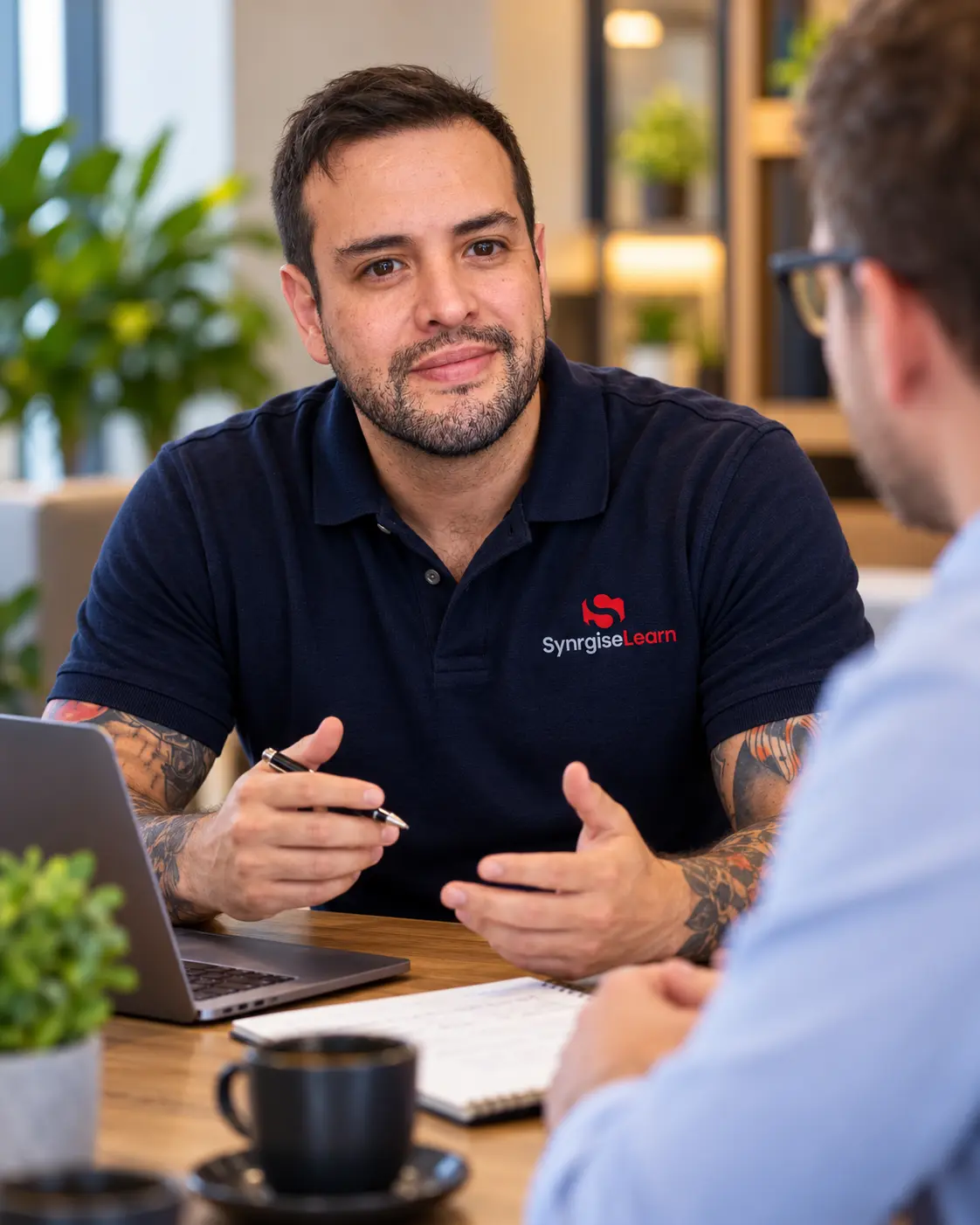 SynrgiseLearn expert Jonny discussing Learning Management System requirements, LMS implementation costs and tailored corporate learning solutions with a prospective client.